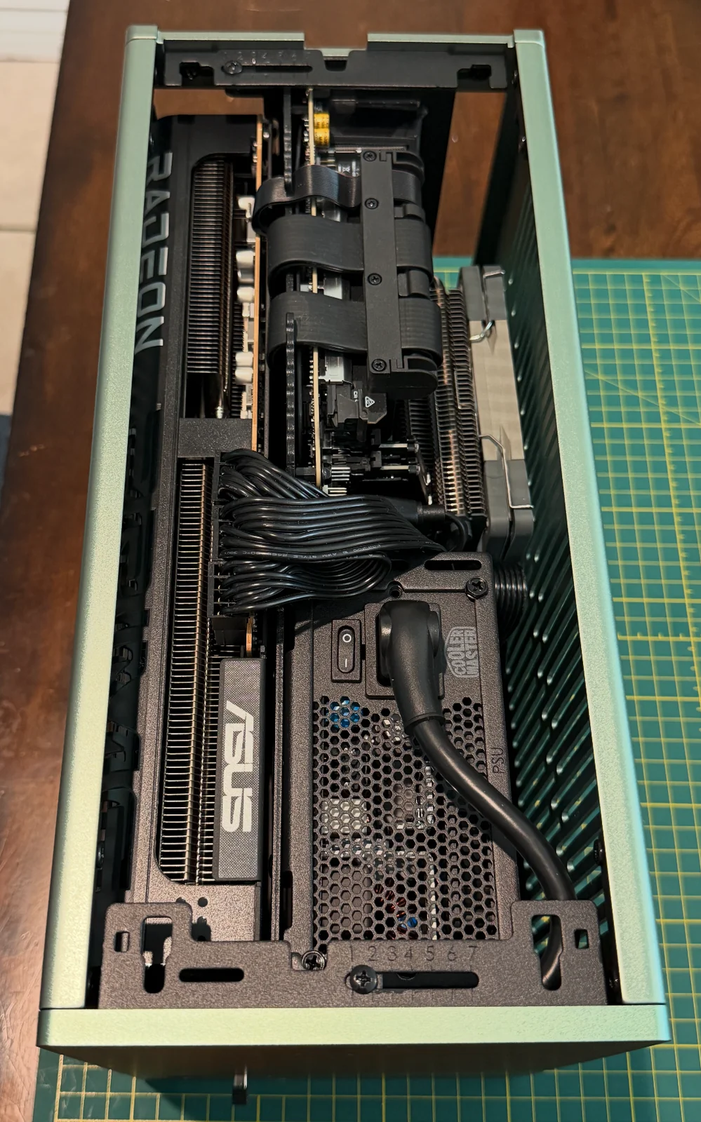 A top-down view inside the Terra, showing cables routed between the graphics card, motherboard, and compact power supply.