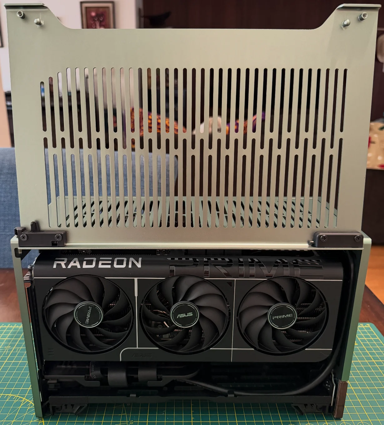 The Terra with its side panel raised, showing the three-fan ASUS Prime Radeon graphics card filling one side of the case.